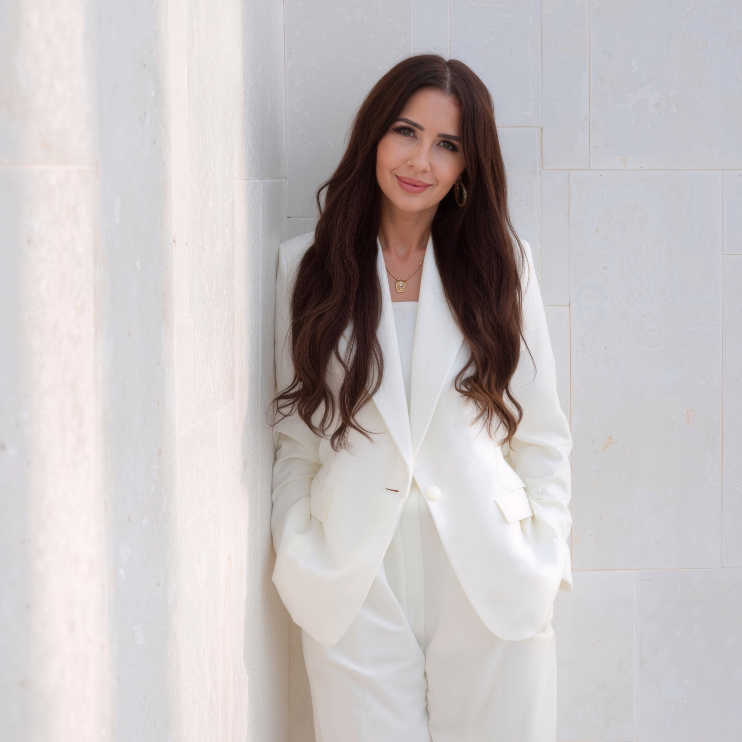 Sri Luxe Elegance and Tradition dar haired woman in a white suit